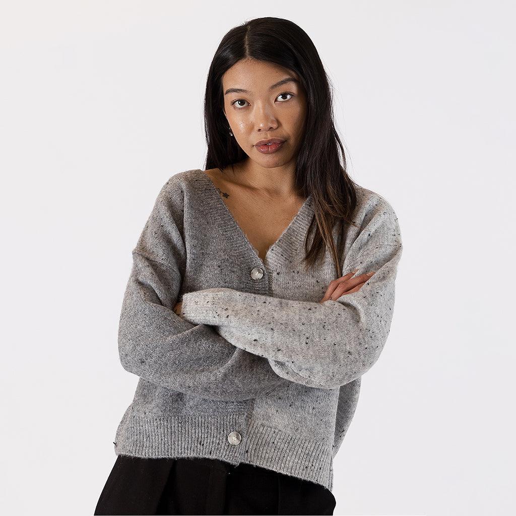 This cardigan features a unique two-tone design with flecks of contrasting color and soft fabric that ensures comfort. Whether you're layering it over a simple tee or dressing it up for a more polished look, this cardigan brings a blend of comfort and style to your everyday ensembles.