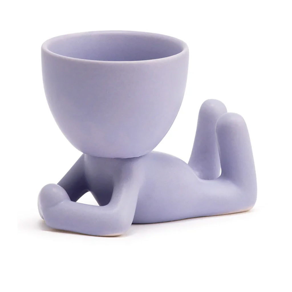 With the ceramic Lavender Lying Person Pot Head, you'll have a charming and compact ceramic pot head that adds a pop of calming lavender tones to any space. Measures 2.5" L x 2.5" W x 1.75" H.