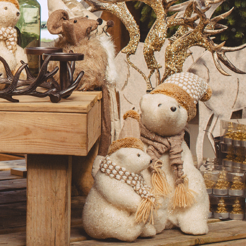A group of teddy bears sitting on a wooden table.