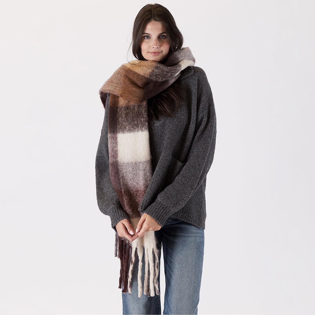 Introducing our Check Scarf in Brown – a timeless accessory that effortlessly complements your wardrobe with its rustic and natural colors. The classic check pattern in warm brown tones adds a touch of elegance to any outfit. 
