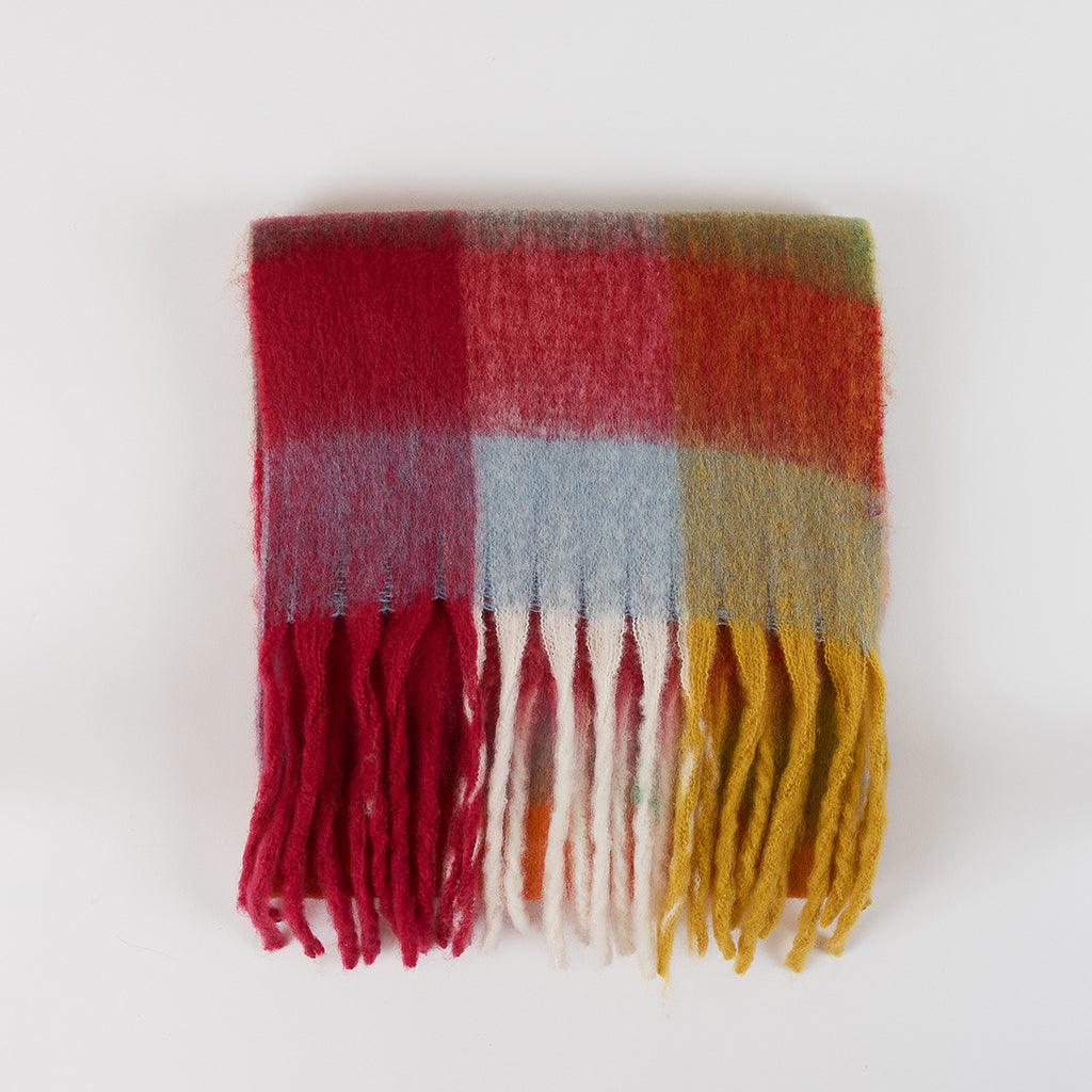 This scarf is not only a functional piece in chilly weather but also a colorful addition that stands out as a statement accessory. Wrap it around yourself to feel the comfort and warmth it brings, while also showcasing your unique style with its dynamic design. 