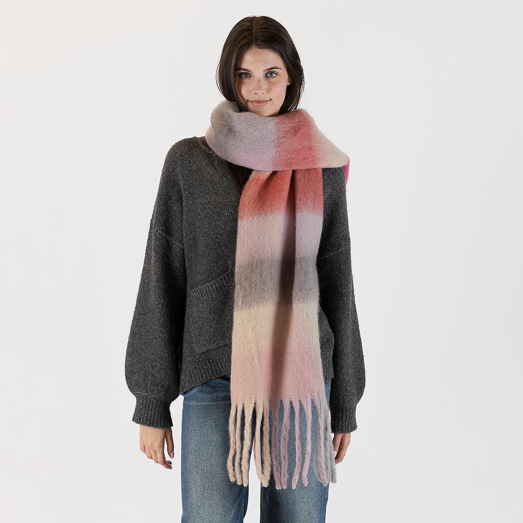 A cozy accessory that brings both warmth and style to your outfit. This scarf features a delightful check pattern in warm, light colors that exude comfort and charm. 