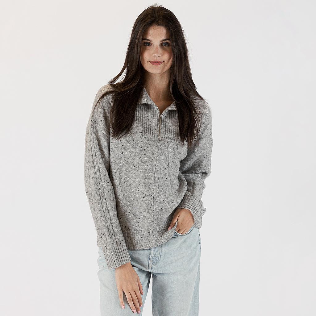 Elevate your fall wardrobe with the 3/4 Zip Ribbed Sweater in Light Grey Fleck. The intricate ribbed design in a timeless light grey shade adds a touch of sophistication to your ensemble. 