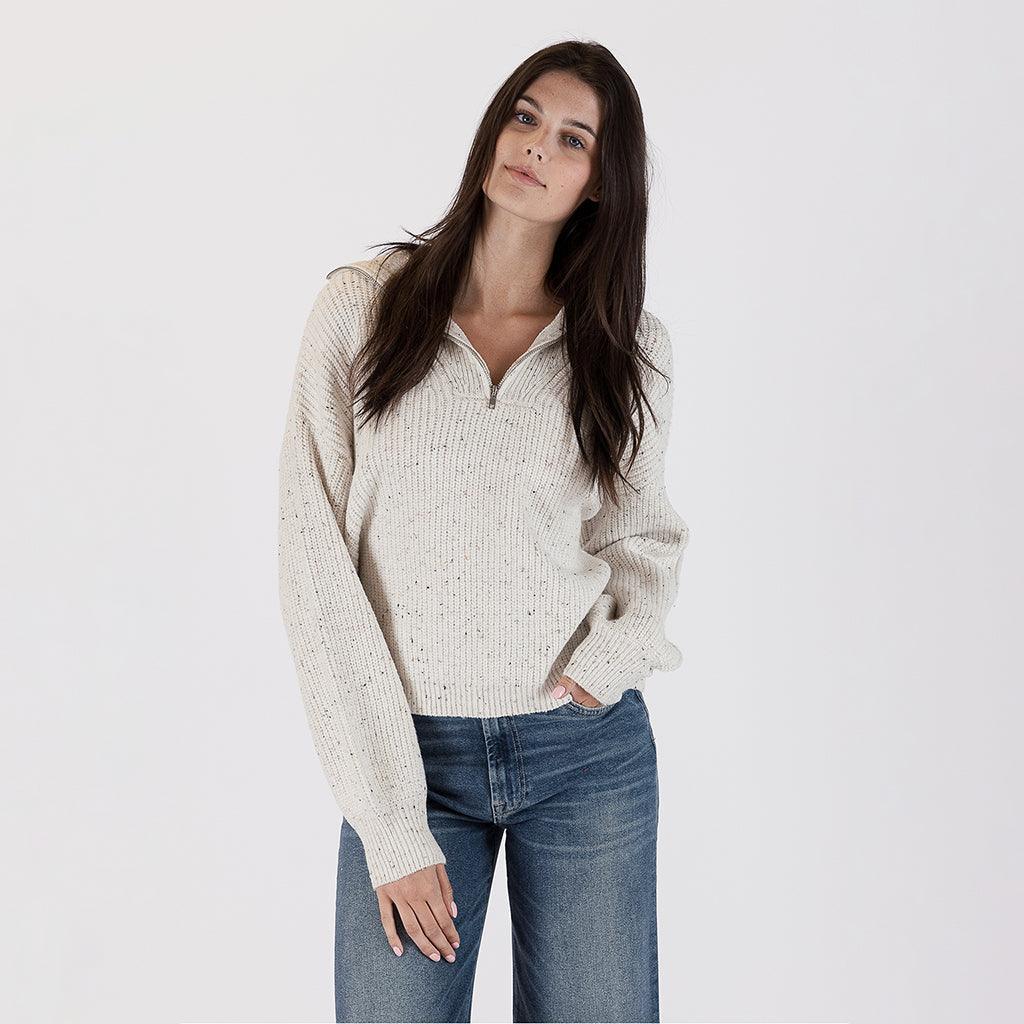 Elevate your autumn wardrobe with our Ribbed 3/4 Zip Sweater in Off White Fleck. This high-quality piece is a versatile addition that effortlessly combines style and comfort.