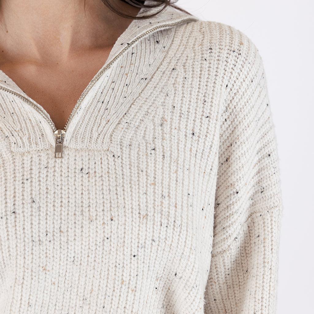 The neutral off-white flecked color makes it a perfect basic for any outfit, allowing you to easily mix and match with your existing wardrobe. 