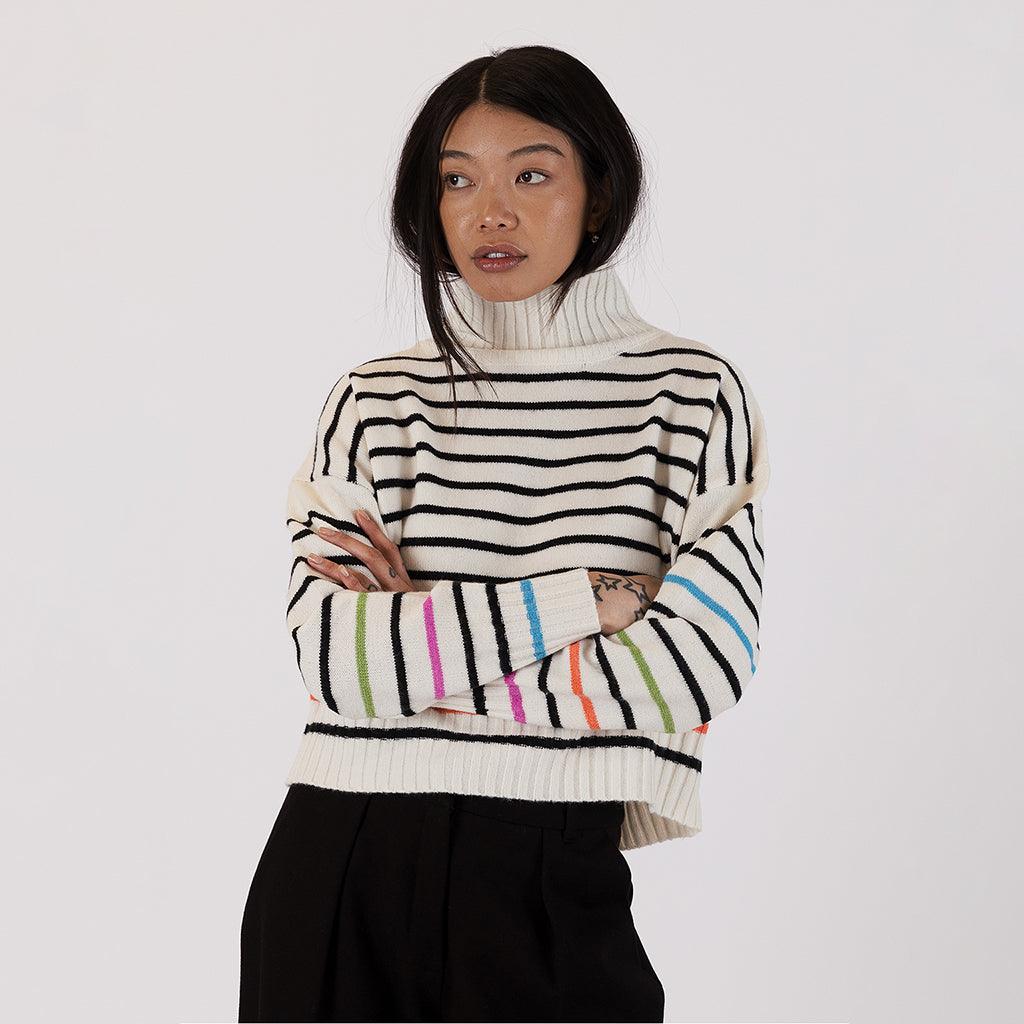 With its vibrant and playful stripes, this sweater stands out as a statement piece that effortlessly infuses energy into your outfits.