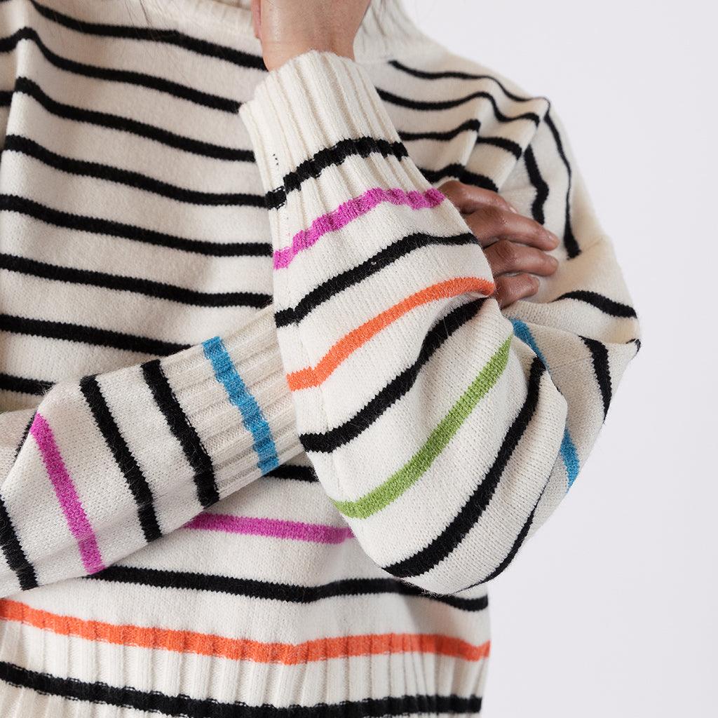 Whether you're looking to add a pop of color to your everyday look or seeking a bold ensemble for a special event, this mock neck striped sweater promises to bring a versatile and unique charm to your style.
