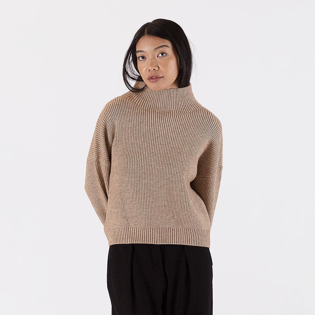 Elevate your autumn wardrobe with our Mock Neck Striped Sweater in Camel. This elegant piece features a ribbed turtle-neck design that exudes sophistication and comfort. The timeless beige colour adds a versatile touch, making it a must-have for your seasonal collection. Crafted with attention to detail and quality, this sweater is an autumn essential that seamlessly complements various outfits. 