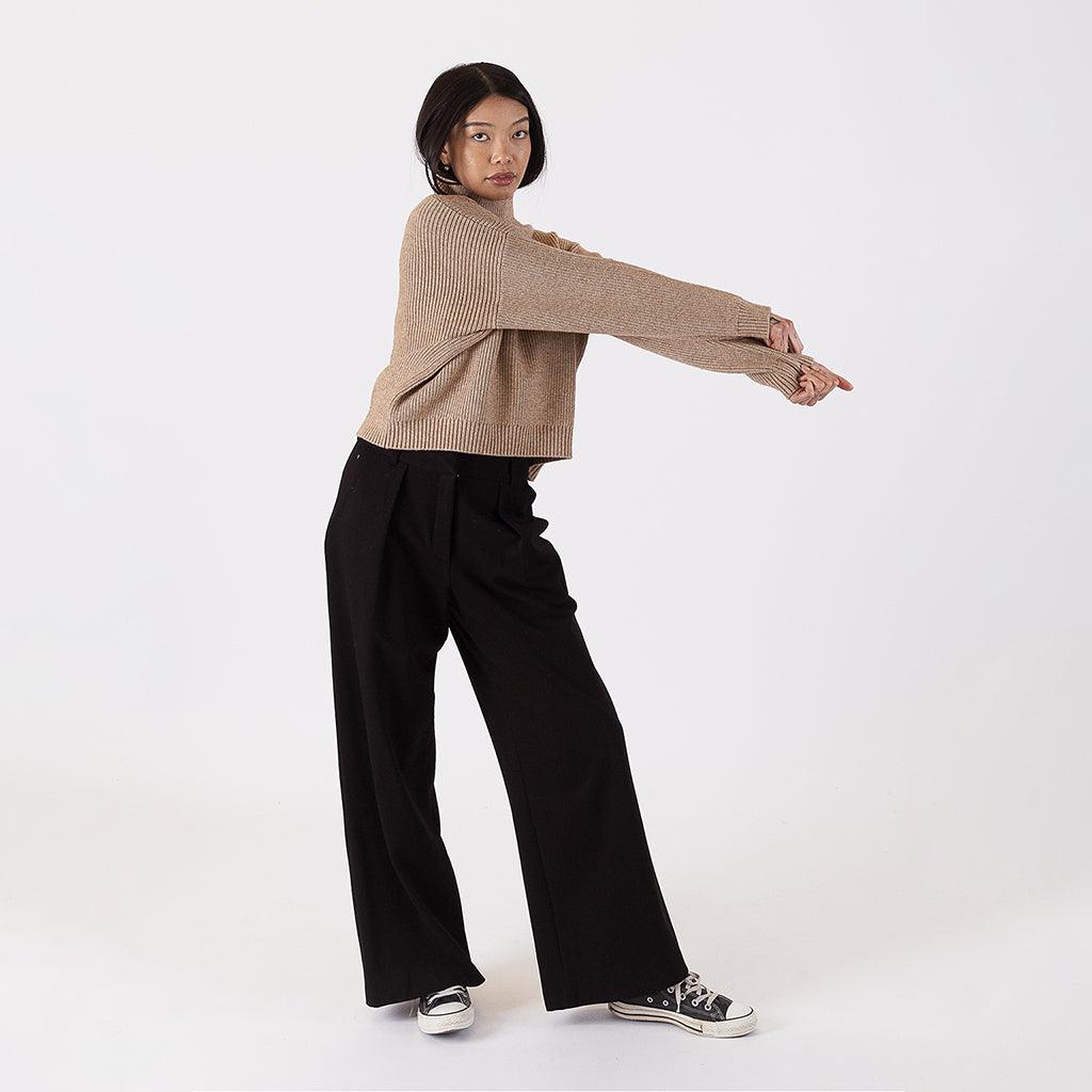 Elevate your autumn wardrobe with our Mock Neck Striped Sweater in Camel. This elegant piece features a ribbed turtle-neck design that exudes sophistication and comfort. 