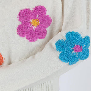 This sweater effortlessly combines classic comfort with a burst of modern flair. The intricate detailing of each flower adds depth and personality to the piece, making it a true standout in your collection. Crafted with meticulous attention to quality and comfort, this sweater boasts a luxurious softness that feels as good as it looks. 