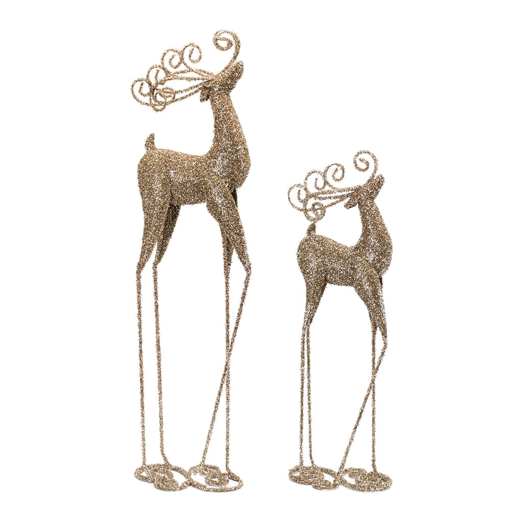 Elevate your holiday décor with the enchanting &quot;Metal Deer Set of 2,&quot; a stunning duo standing at 24.5 inches and 32.75 inches in height. Crafted with a touch of opulence, these deer figures feature a gold glittery finish that adds a festive sparkle to any setting.