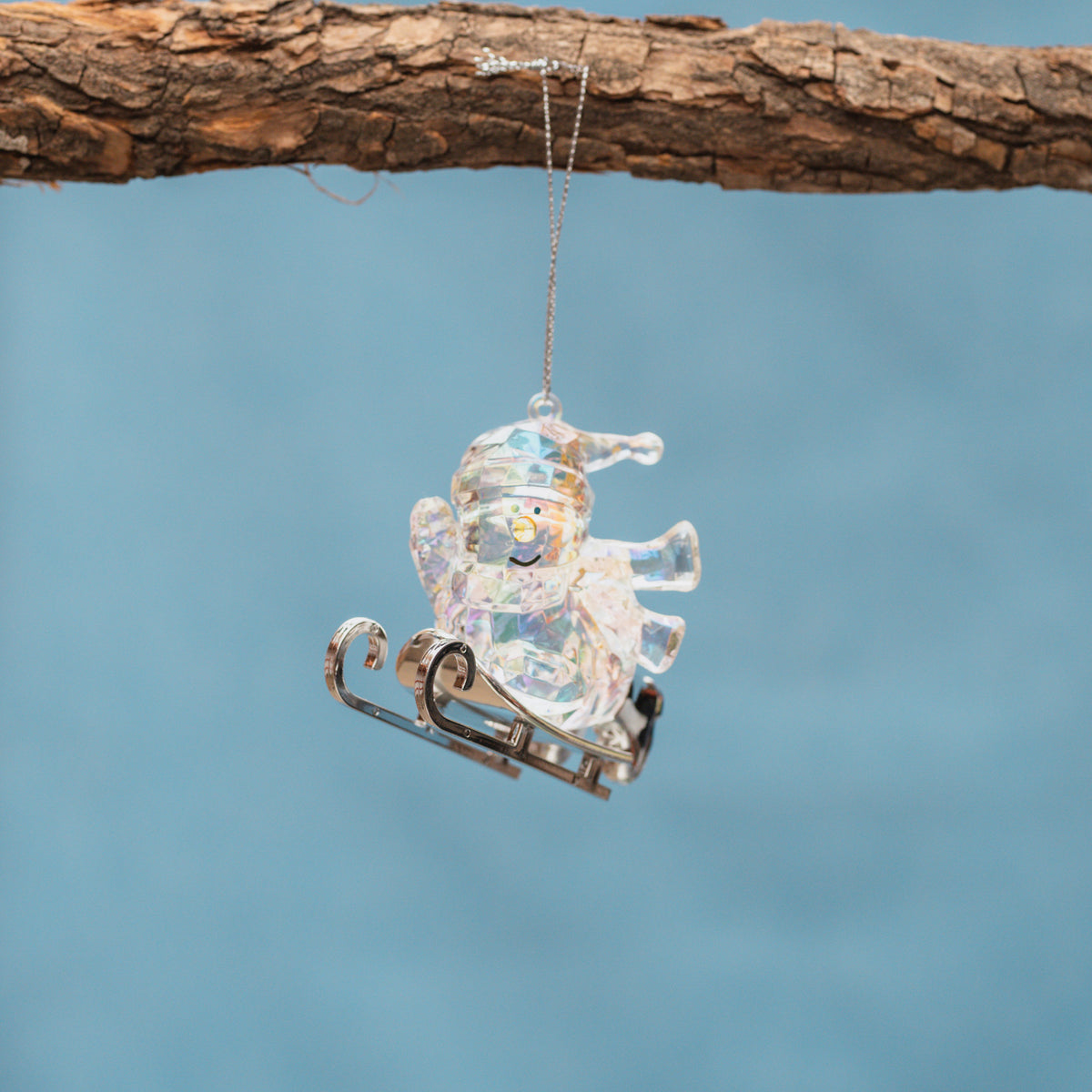Opalescent Snowman Sledding Ornament