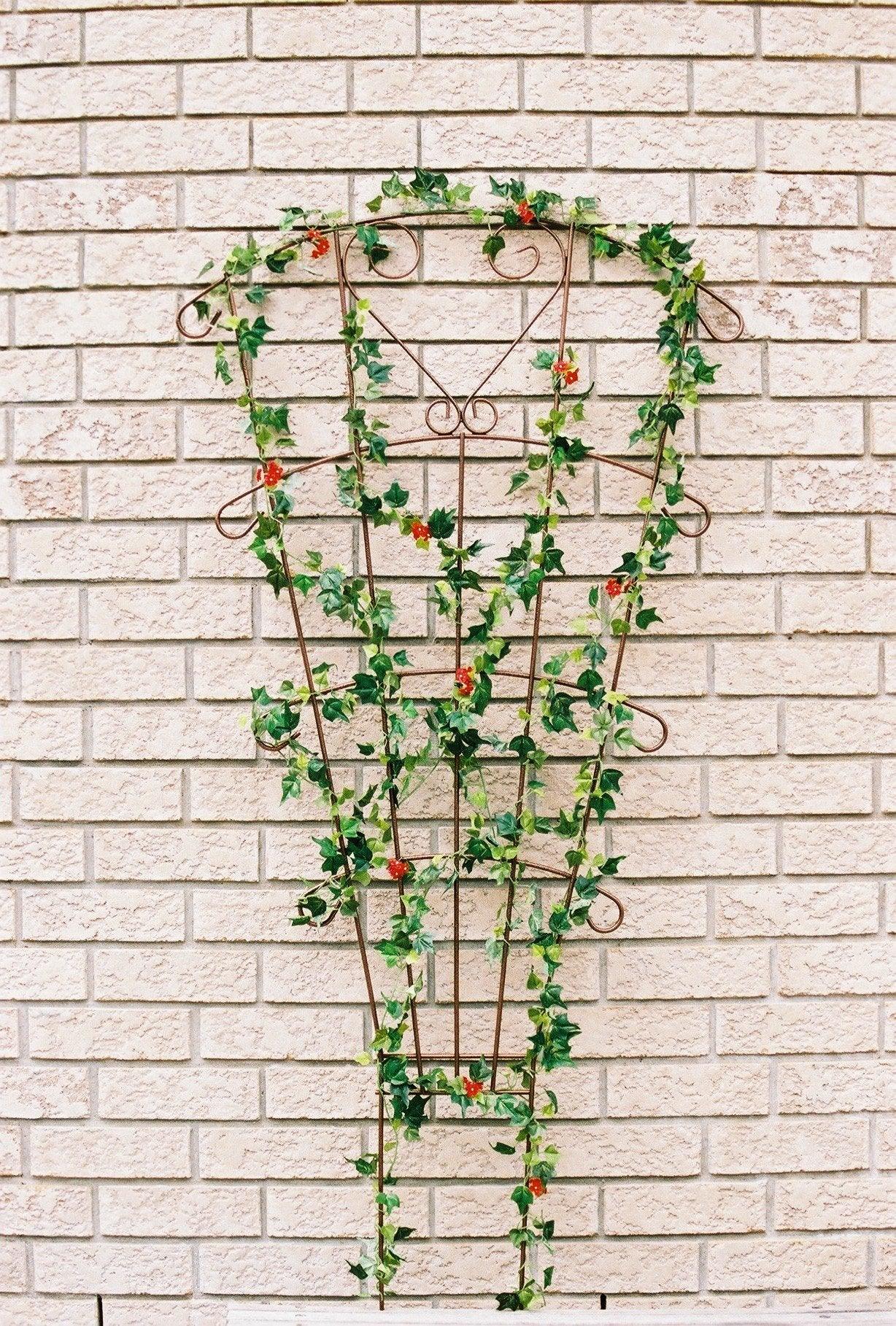 Enhance your garden with the Versailles Fan Trellis. With its sturdy construction and elegant design, this trellis is perfect for training climbing plants and adding a touch of charm to your outdoor space. Upgrade your gardening game with this beautiful and functional trellis.