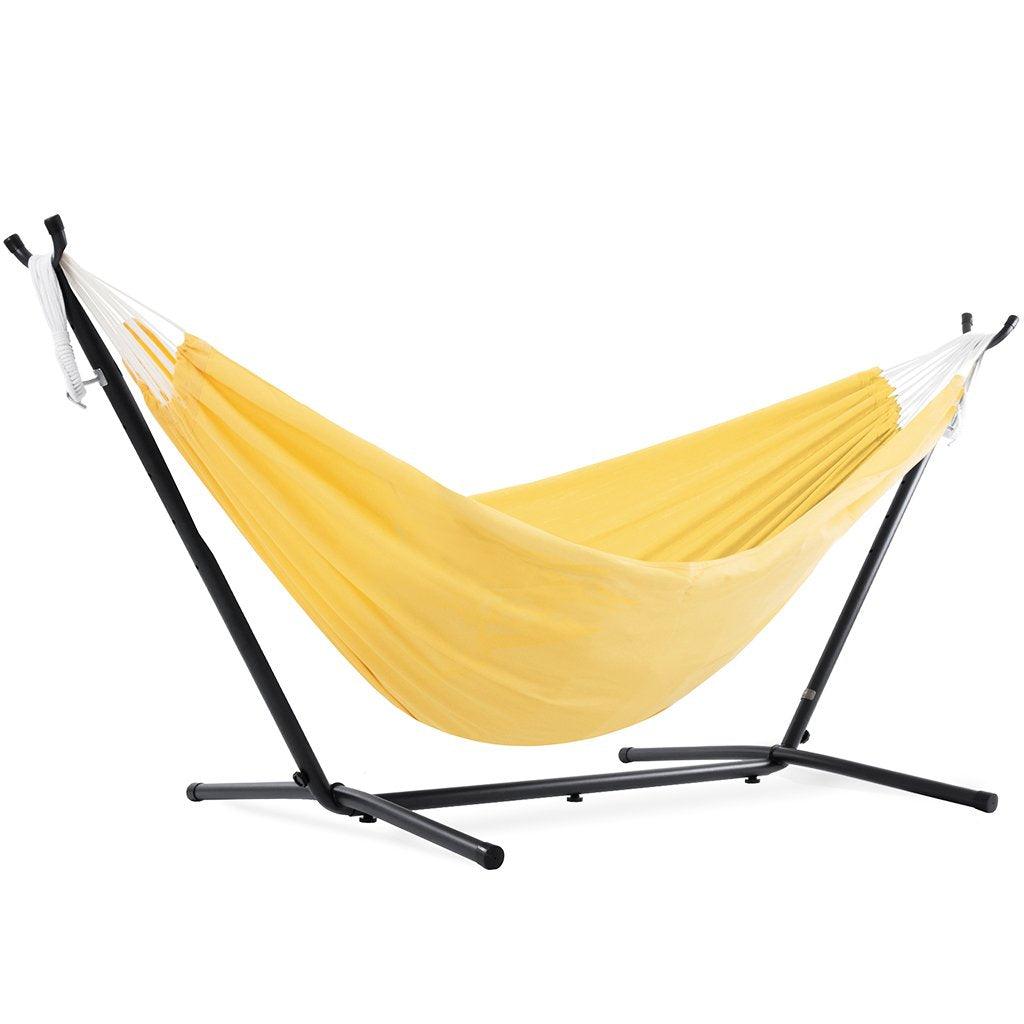 This nine-foot polyester hammock combo in sunny yellow is the ideal addition to any outdoor living space. Boasting the perfect balance of strength and comfort, you'll be basking in the warmth of the sun in no time.