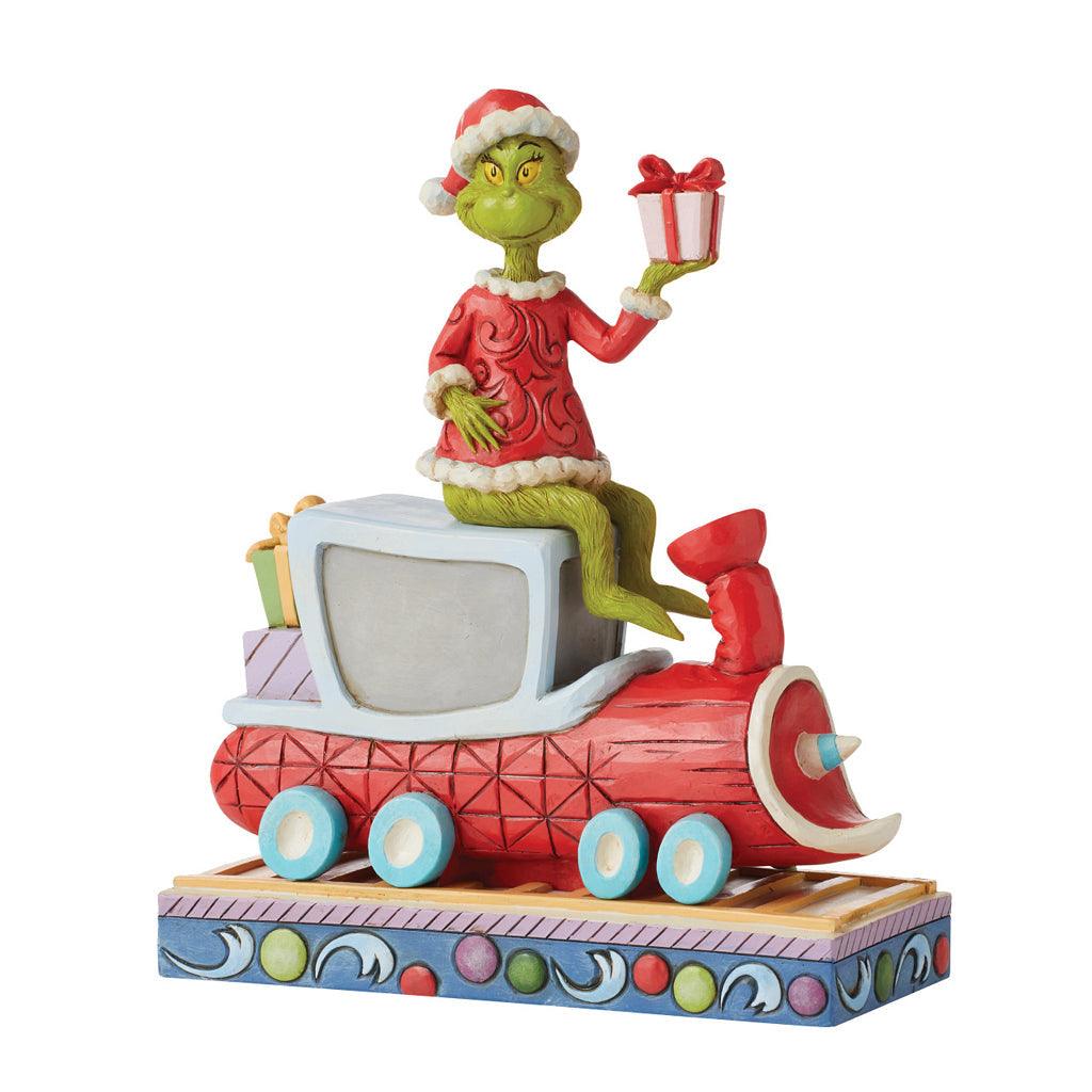 A figurine of a santa riding on a train.