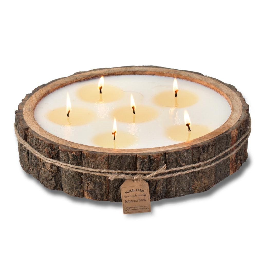 Embrace the rustic charm with the Himalayan Tree Bark Pot 6-Wick Candle, featuring the delightful Grapefruit Pine scent in a generous 76oz size. This candle is uniquely hand-carved from the bark of the Mango tree, bringing a touch of nature&#39;s beauty into your space. With dimensions measuring 12x2.75&quot;, the candle exudes an earthy and rustic look, perfect for adding character to your décor. 