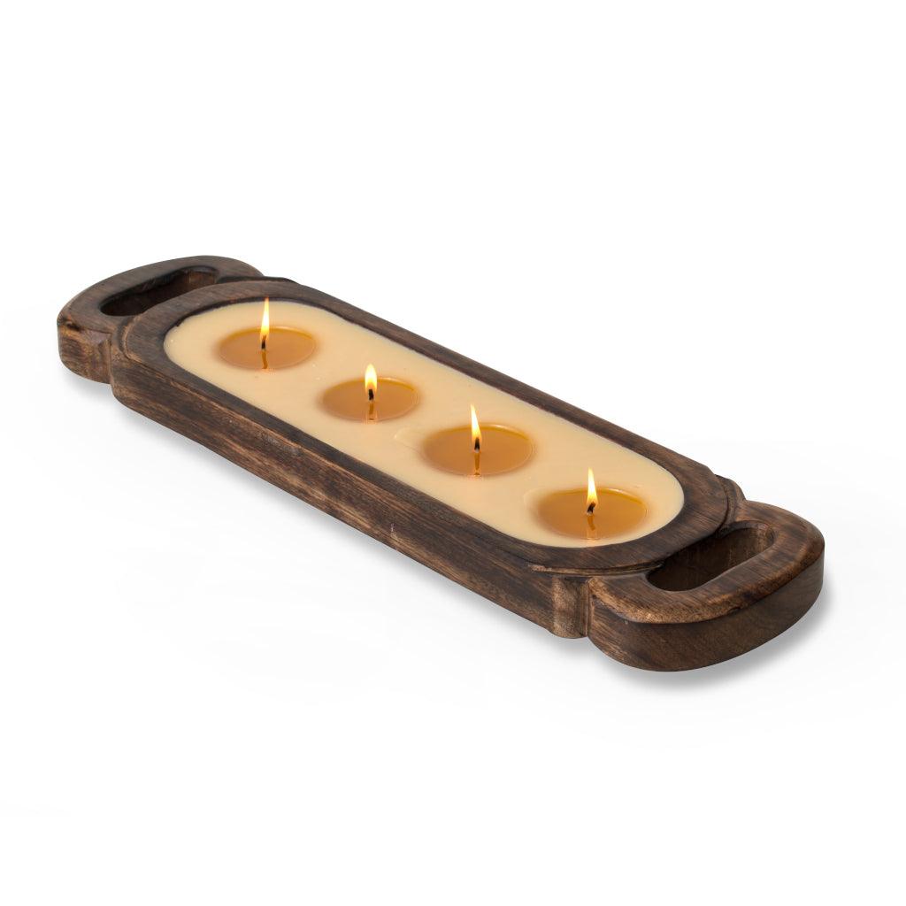 This 40oz candle is nestled in an exquisite tray with an antiqued appearance, hand-crafted from a single slab of sustainable mango wood, measures 23inches by 5inches. Each tray is a unique work of art due to its hand-hewn and carved design, adding a touch of rustic elegance to your décor. 