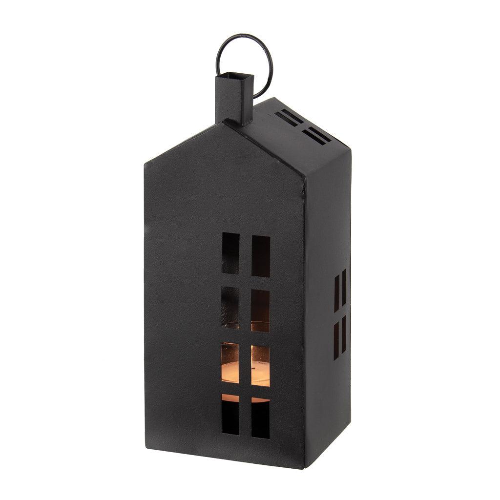 This tall lantern, standing at 8.75 inches in height, is crafted from durable black powder-coated metal. Its elegant design resembles a charming house, making it a decorative piece that also serves a functional purpose. Measuring 3.75 x 3.25 x 8.75 inches, it's perfectly sized to hold your favorite tealight candle.
