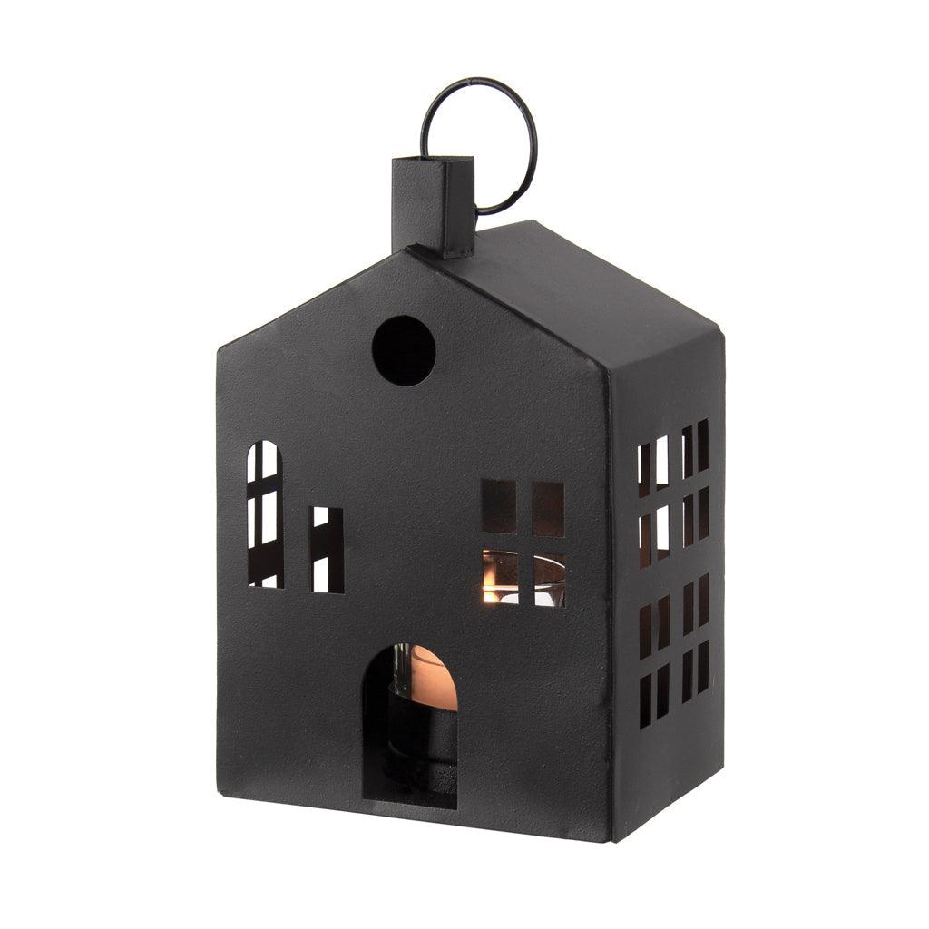 Crafted from sturdy black powder-coated metal, this lantern resembles a charming house, adding a touch of elegance to any space. Measuring 4.75 x 3.25 x 7.25 inches, it&#39;s just the right size for your favorite tealight candle. Whether used indoors or outdoors, this lantern not only provides a warm and inviting glow but also serves as a decorative accent in any setting.