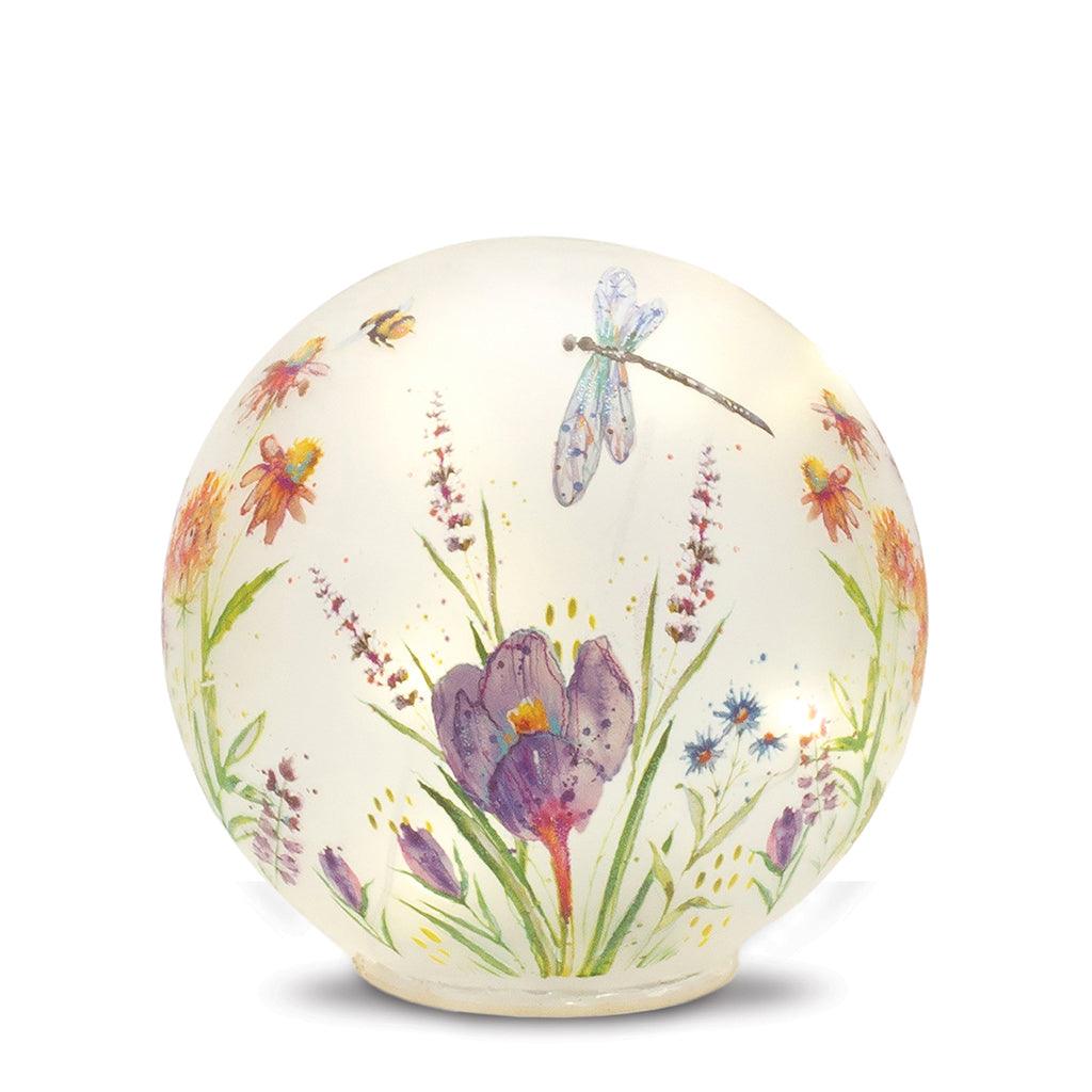 Create a warm and welcoming ambiance for any room in your home with this beautiful decorative glass globe. The LED lights illuminate a stunning floral display, perfect for adding a touch of elegance to your living space.