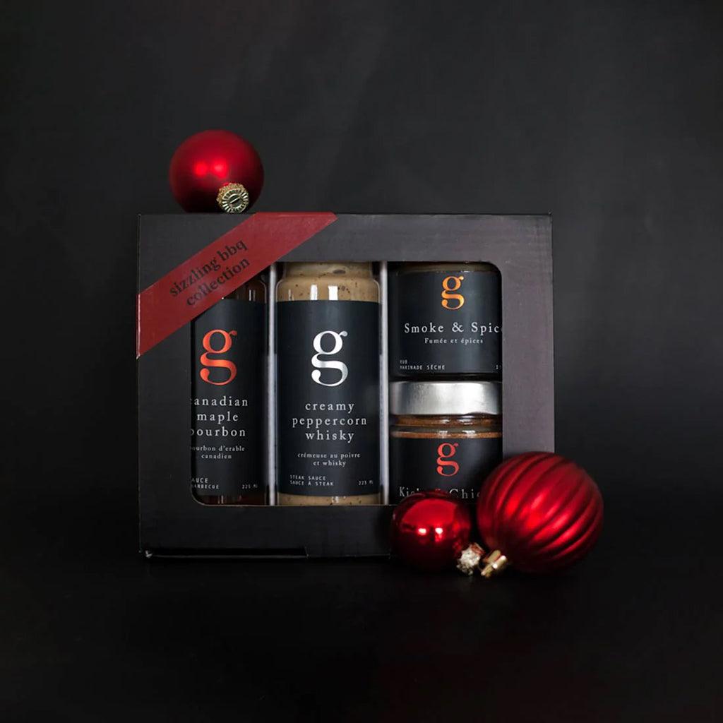 A gift hamper of a gourmet whisky on a black background.