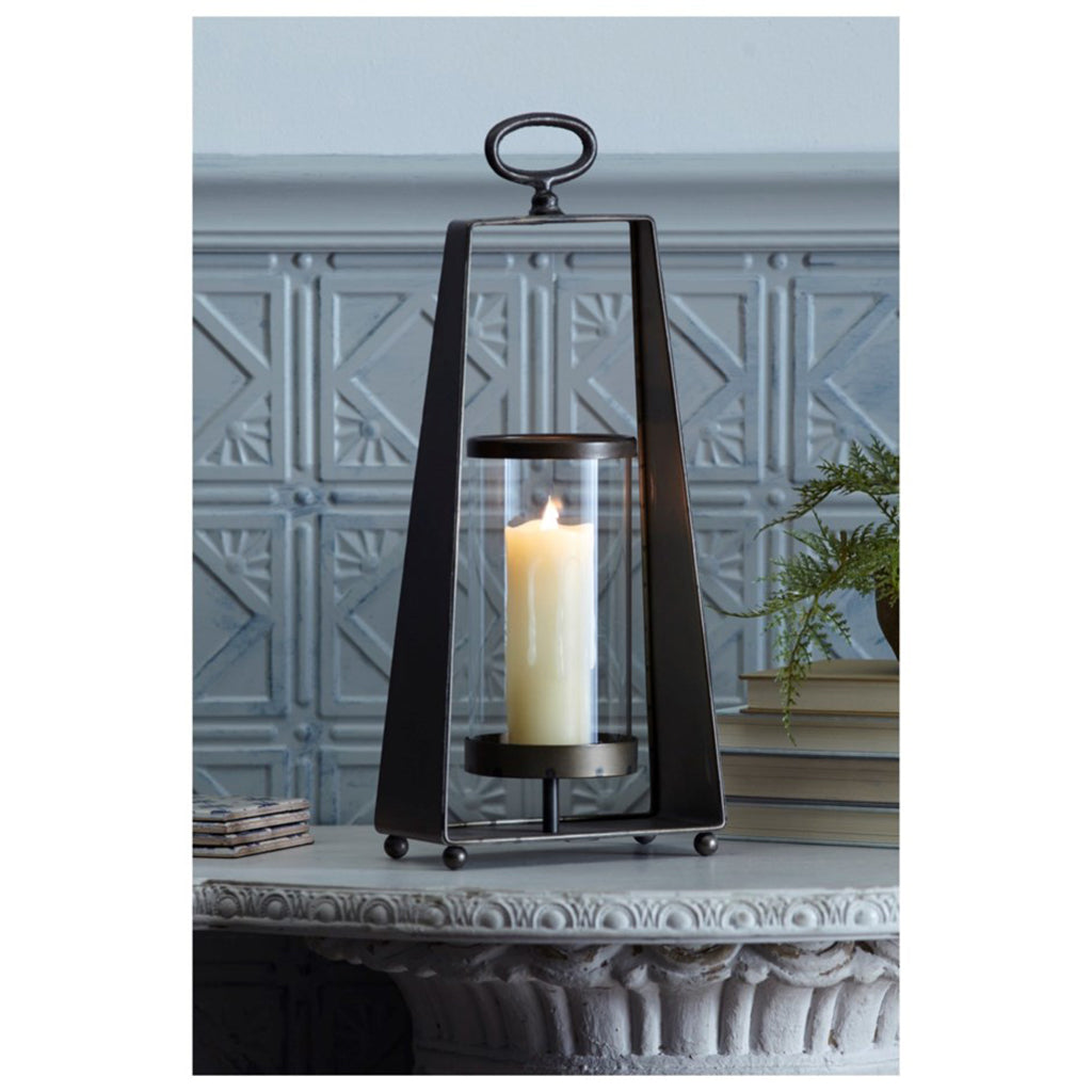 Equip your home with this stylish and modern candleholder. Enjoy the warm glow of candlelight while keeping your surfaces safe with the included glass holder. Stands 18inches tall.